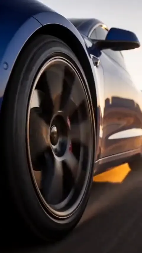 A sports car on an open road in warm light